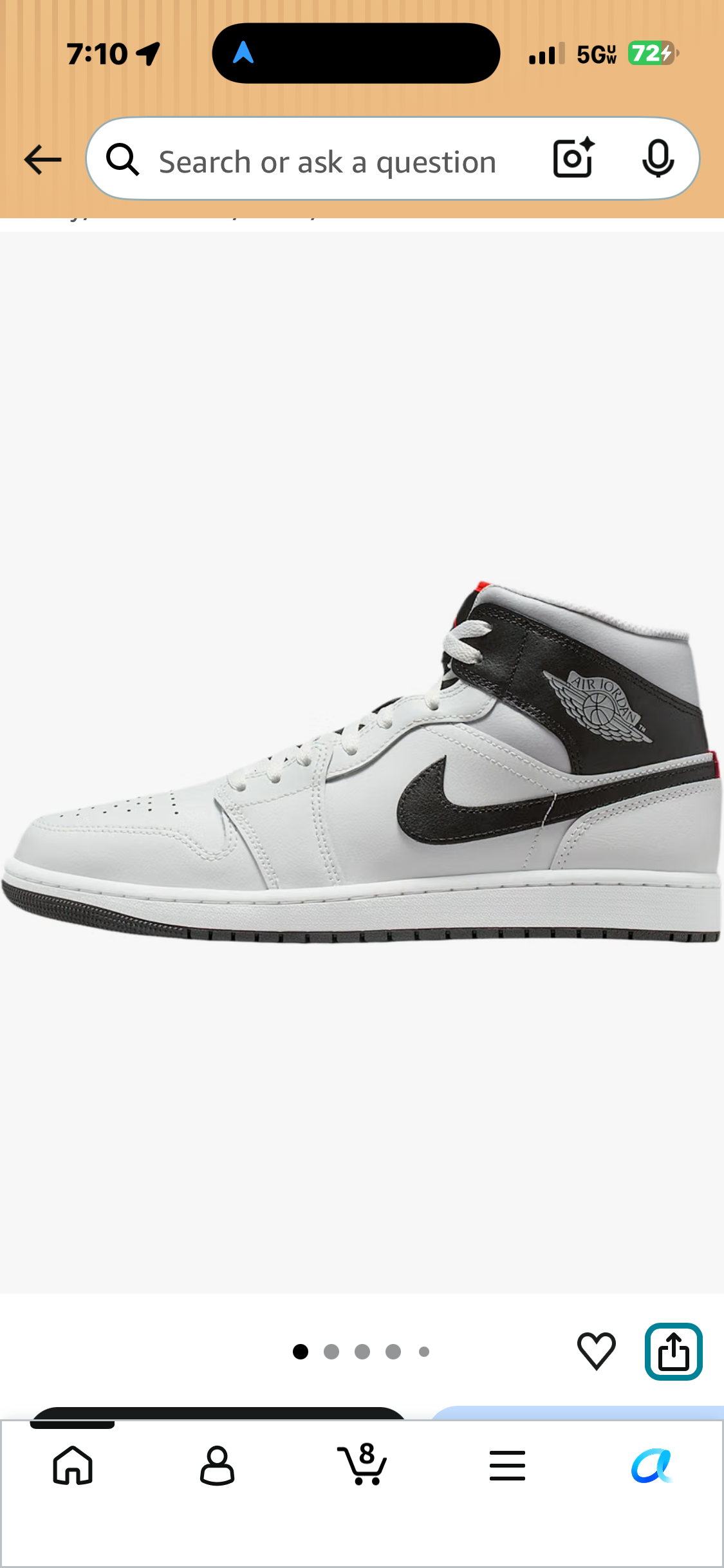 White and black Air Jordan sneaker with a black Swoosh, Air Jordan Wings logo, and small red accents