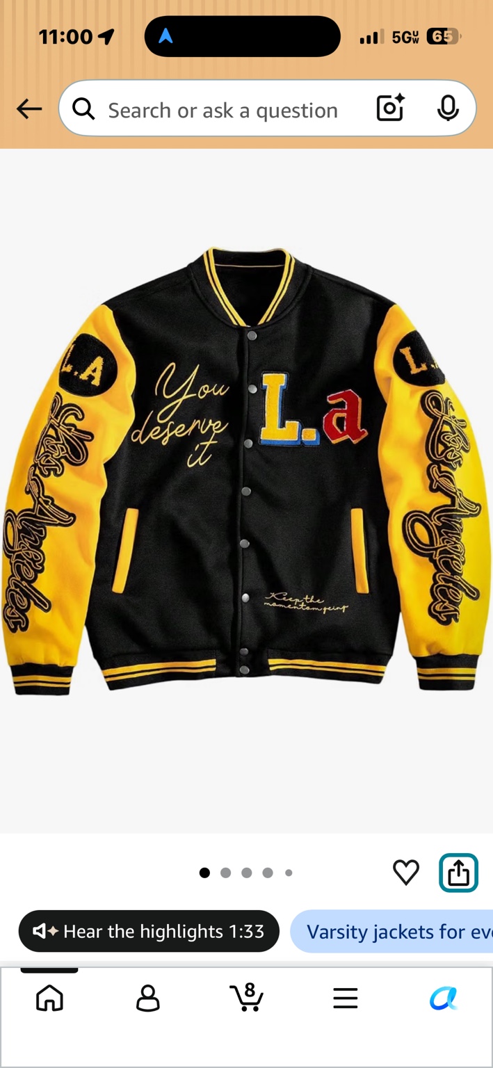 Black varsity jacket with yellow sleeves, LA lettering and snap-button front